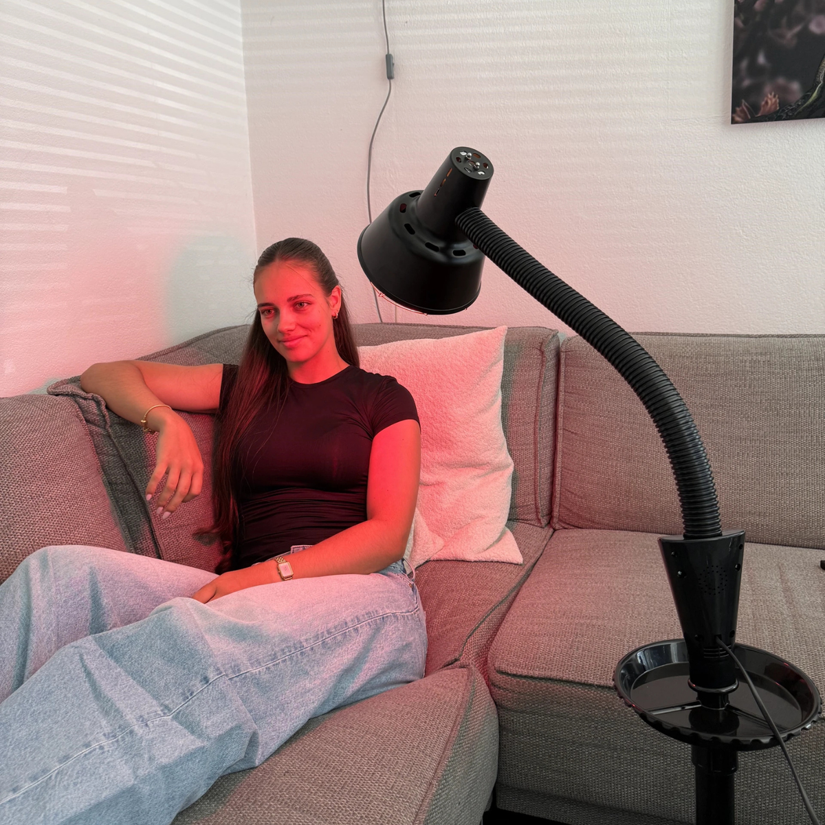 Redlight 160 infrared lamp on its stand next to the sofa in the living room
