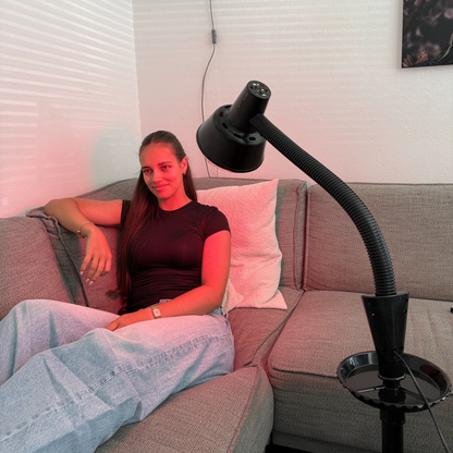 Redlight 160 infrared lamp on its stand next to the sofa in the living room